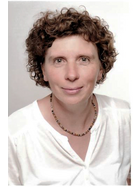Frau mit kurzen braunen Locken und weißer Bluse
